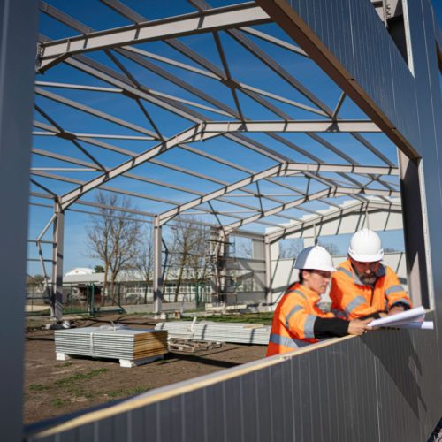 Civil Engineers Team at Construction Site. Building with Met